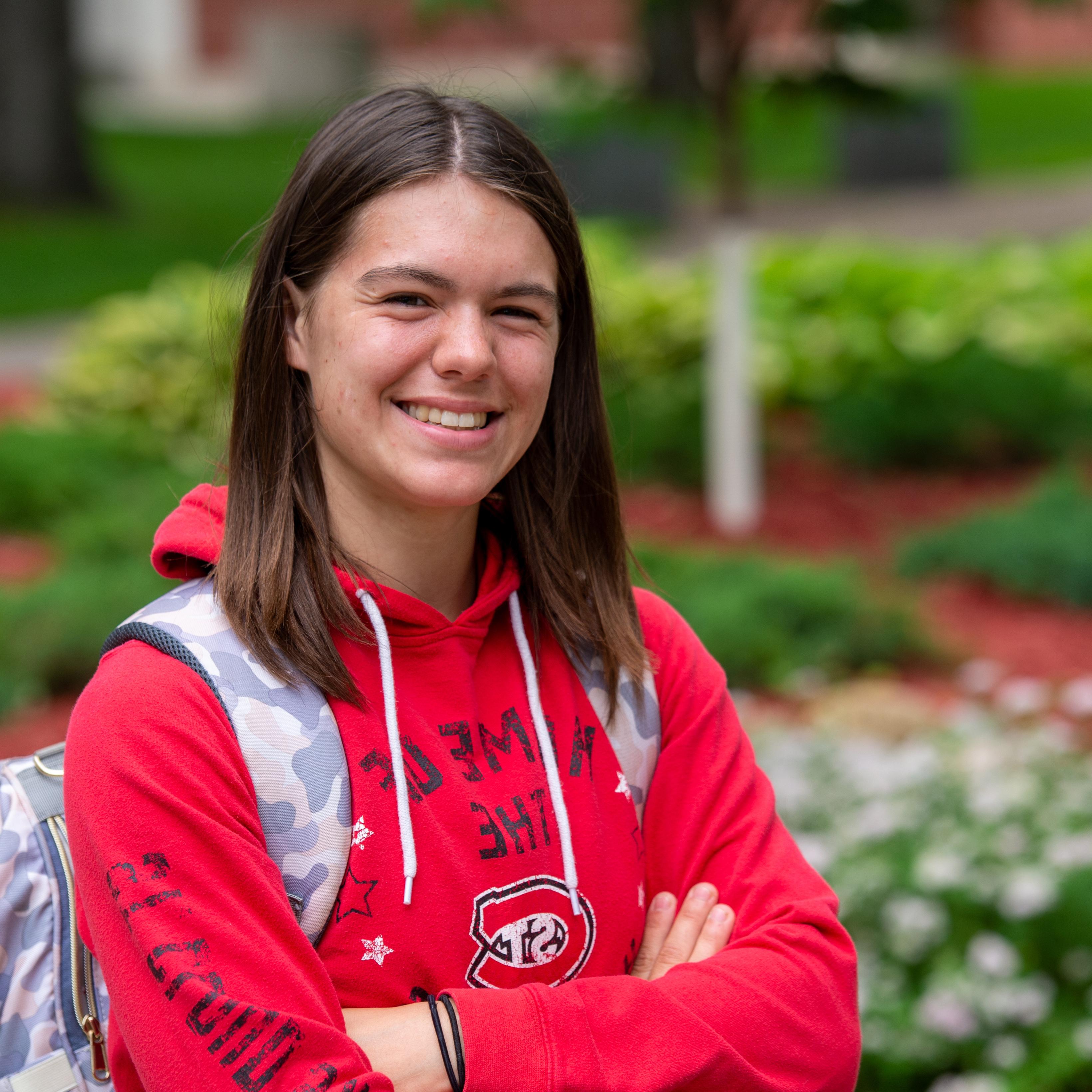 Student with backpack smiling.